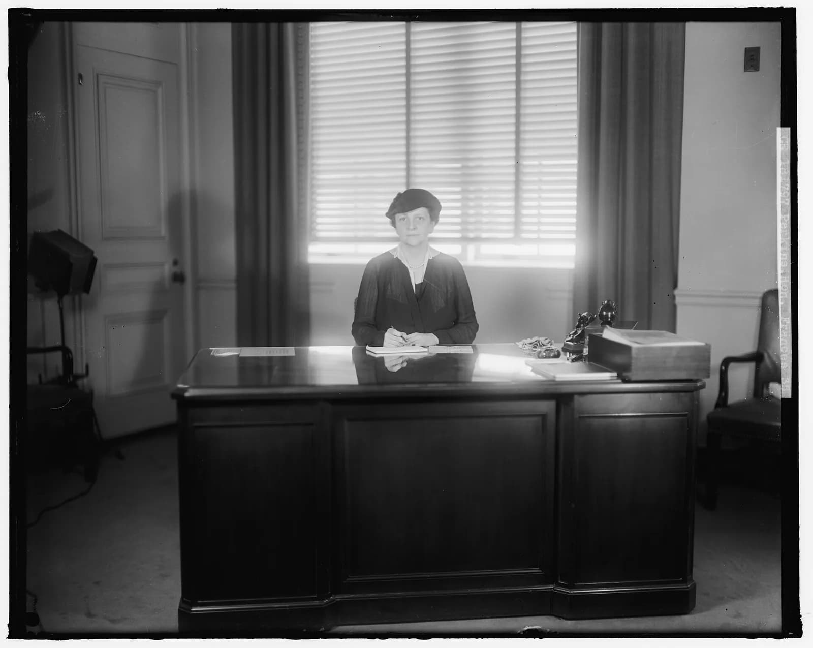Frances Perkins, Secretary of Labor from 1933 to 1945, seated at her office desk