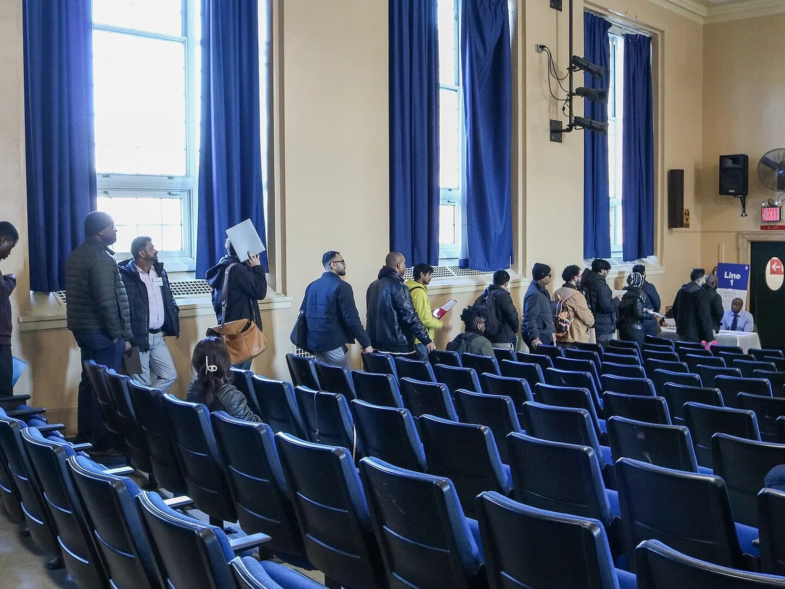 Applicants lined up at an NYC Transit job fair in Brooklyn; a job fair is one of the recruitment steps a PERM case can use
